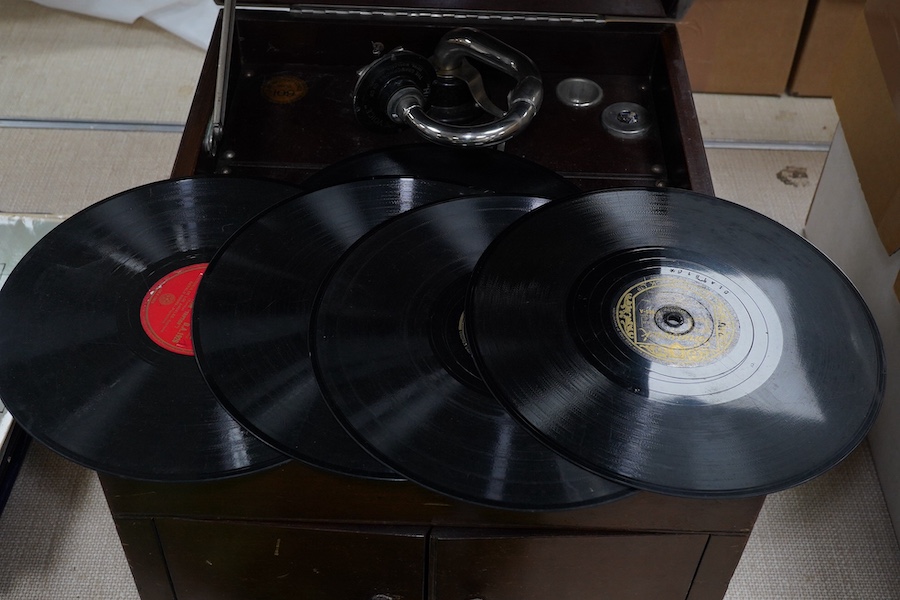 A mahogany cased HMV table top gramophone record player and a small selection of 78 rpm records. Condition - fair to good.